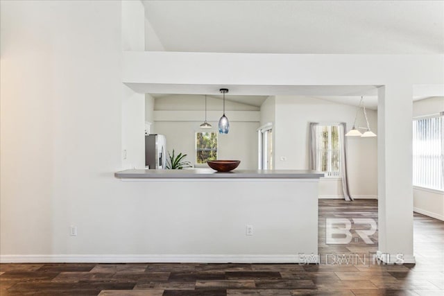 kitchen with lofted ceiling, plenty of natural light, and stainless steel fridge with ice dispenser