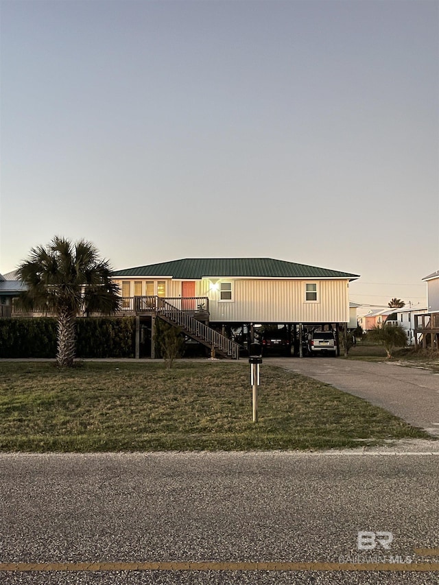 view of front of home with stairway and a front lawn