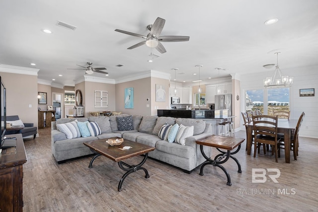 1402 W Dune Dr, Gulf Shores, AL 36542 - living room with ceiling fan with notable chandelier, light wood-style floors, ornamental molding, visible vents, and recessed lighting