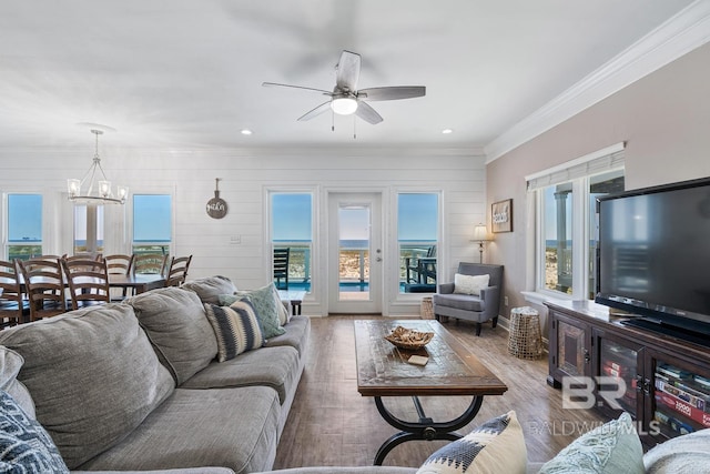 1402 W Dune Dr, Gulf Shores, AL 36542 - living room featuring ceiling fan with notable chandelier, wood finished floors, recessed lighting, and crown molding
