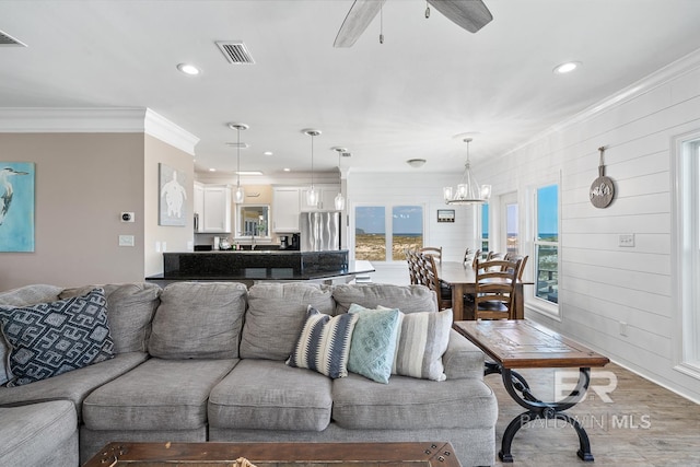 1402 W Dune Dr, Gulf Shores, AL 36542 - living area with ceiling fan with notable chandelier, visible vents, recessed lighting, and ornamental molding