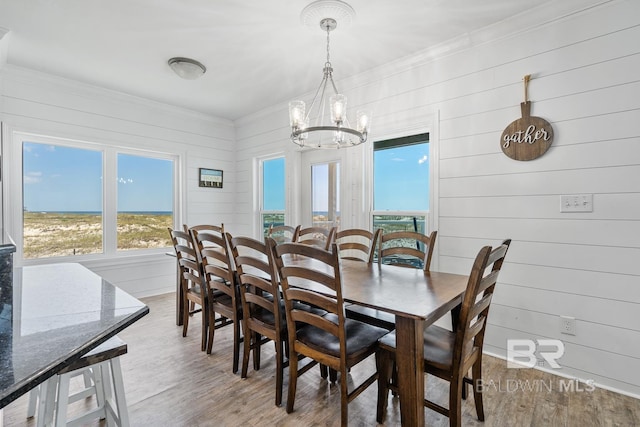 1402 W Dune Dr, Gulf Shores, AL 36542 - dining room with wooden walls, wood finished floors, crown molding, and a notable chandelier