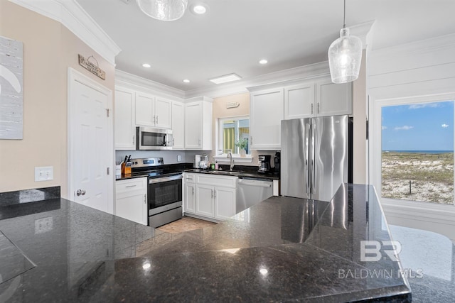 1402 W Dune Dr, Gulf Shores, AL 36542 - kitchen featuring stainless steel appliances, a sink, white cabinetry, and ornamental molding