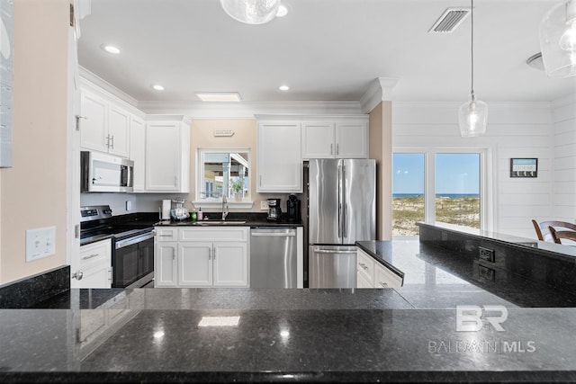 1402 W Dune Dr, Gulf Shores, AL 36542 - kitchen with stainless steel appliances, visible vents, a sink, crown molding, and white cabinetry