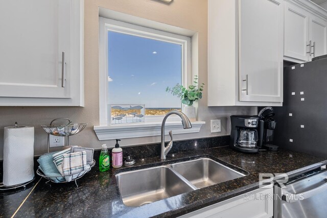 1402 W Dune Dr, Gulf Shores, AL 36542 - kitchen featuring dishwasher, dark stone countertops, white cabinetry, and a sink
