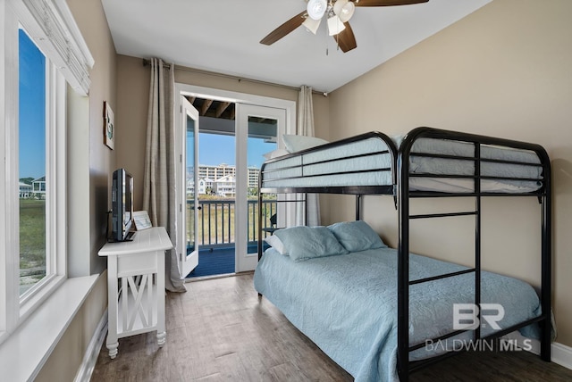 1402 W Dune Dr, Gulf Shores, AL 36542 - bedroom featuring wood finished floors, a ceiling fan, baseboards, and access to outside