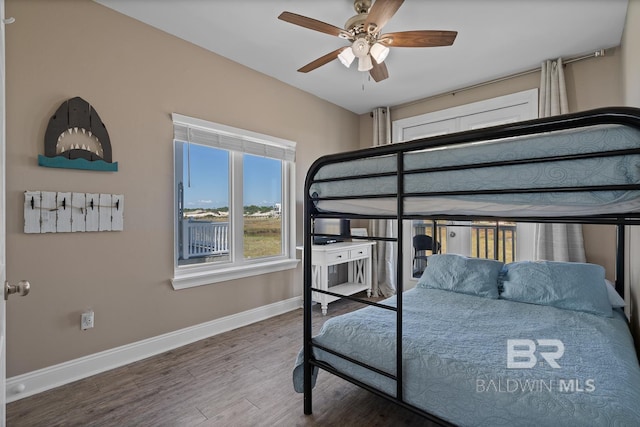 1402 W Dune Dr, Gulf Shores, AL 36542 - bedroom with ceiling fan, baseboards, and wood finished floors