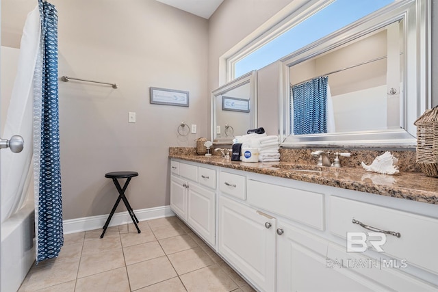 1402 W Dune Dr, Gulf Shores, AL 36542 - full bath featuring a sink, curtained shower, double vanity, baseboards, and tile patterned flooring