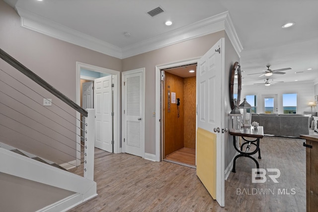 1402 W Dune Dr, Gulf Shores, AL 36542 - foyer entrance featuring stairway, wood finished floors, visible vents, a ceiling fan, and crown molding