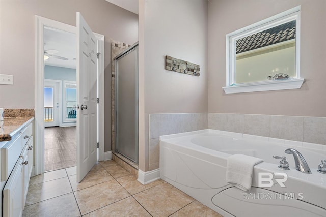 1402 W Dune Dr, Gulf Shores, AL 36542 - bathroom with vanity, a garden tub, a stall shower, and tile patterned floors