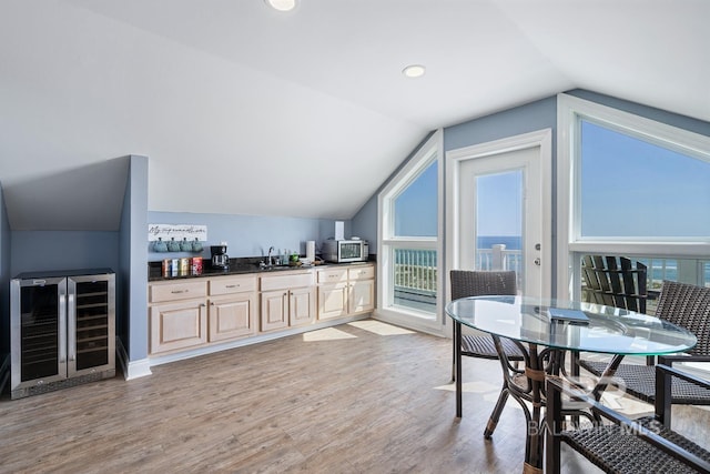 1402 W Dune Dr, Gulf Shores, AL 36542 - bar with a sink, light wood-type flooring, stainless steel microwave, lofted ceiling, and wine cooler