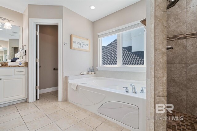1402 W Dune Dr, Gulf Shores, AL 36542 - bathroom with tile patterned floors, a bath, vanity, baseboards, and tiled shower