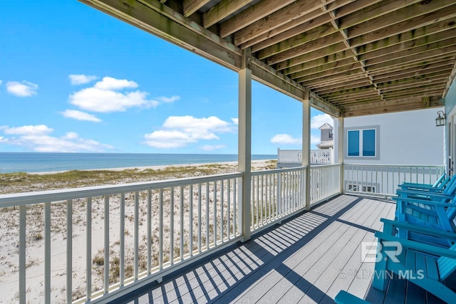 1402 W Dune Dr, Gulf Shores, AL 36542 - wooden deck featuring a beach view, a water view, and a carport
