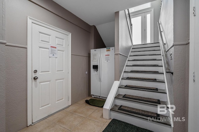 1402 W Dune Dr, Gulf Shores, AL 36542 - stairway featuring a textured wall and tile patterned flooring