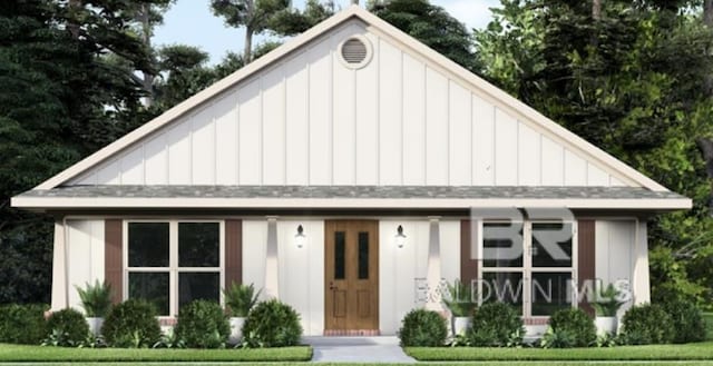 modern inspired farmhouse with a shingled roof and board and batten siding