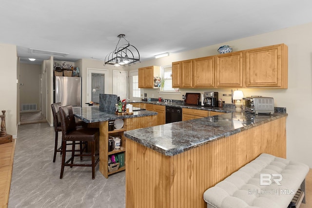 24675 Ulrich Ln, Elberta, AL 36530 - kitchen featuring freestanding refrigerator, black dishwasher, a center island, a breakfast bar, and a peninsula