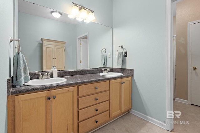 24675 Ulrich Ln, Elberta, AL 36530 - bathroom with double vanity, tile patterned floors, and baseboards