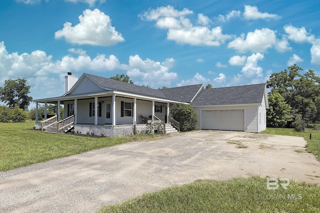 24675 Ulrich Ln, Elberta, AL 36530 - view of front facade featuring covered porch, concrete driveway, a garage, a chimney, and a front yard
