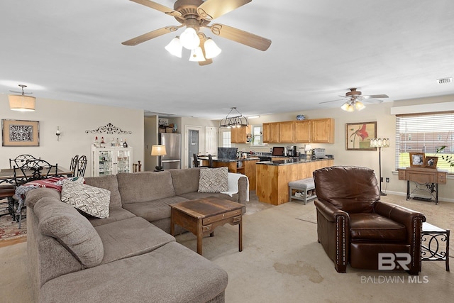 24675 Ulrich Ln, Elberta, AL 36530 - living room featuring a ceiling fan, healthy amount of natural light, light carpet, and baseboards