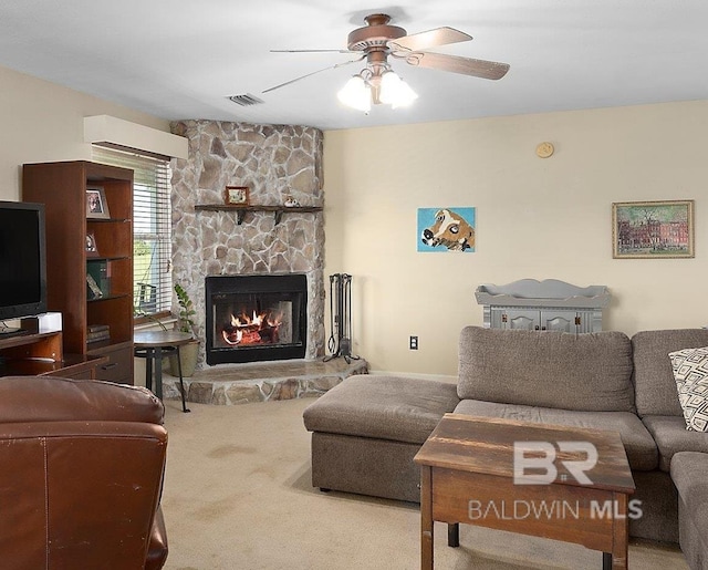 24675 Ulrich Ln, Elberta, AL 36530 - living room with carpet floors, a ceiling fan, and a stone fireplace