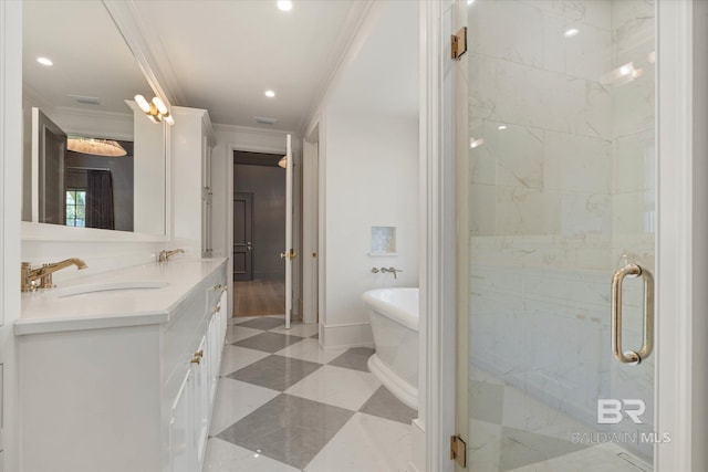 bathroom featuring crown molding, a freestanding bath, a shower stall, double vanity, and recessed lighting
