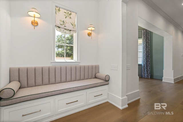 sitting room featuring dark wood finished floors, baseboards, and crown molding