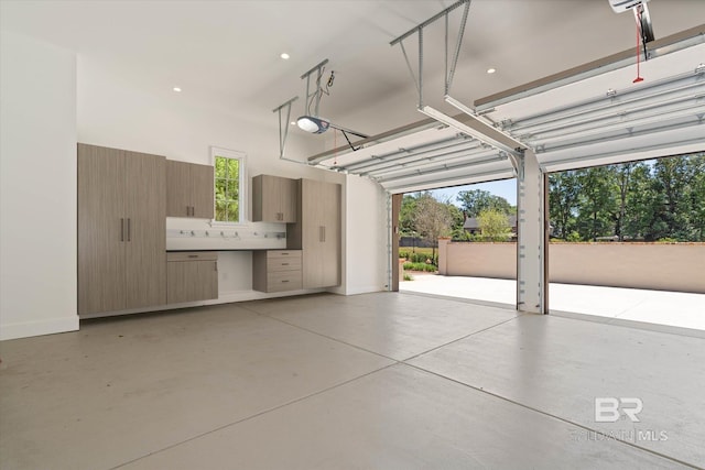 garage with baseboards and recessed lighting