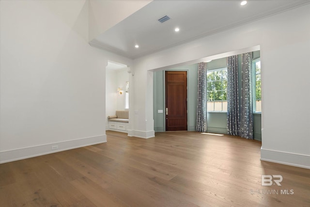 entrance foyer featuring crown molding, hardwood / wood-style floors, baseboards, and recessed lighting