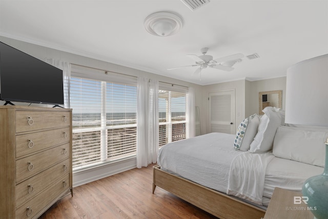 bedroom featuring ornamental molding, ceiling fan, and hardwood / wood-style flooring