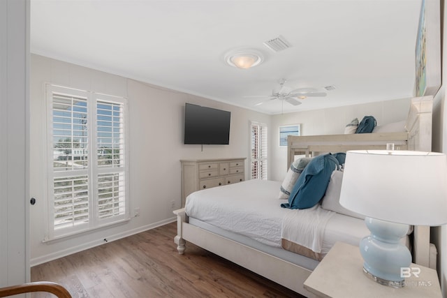 bedroom with ceiling fan, hardwood / wood-style flooring, and ornamental molding