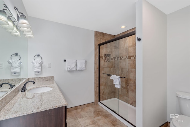 bathroom with vanity, toilet, an enclosed shower, and tile patterned floors