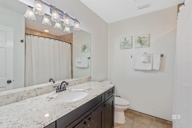 bathroom featuring vanity, toilet, and tile patterned floors