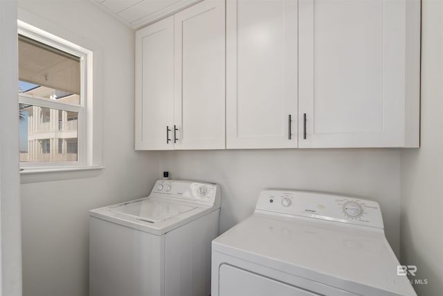 washroom featuring washer and dryer and cabinets