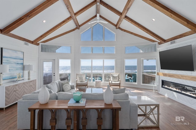 living room featuring beam ceiling and a wealth of natural light