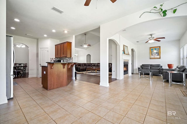 kitchen featuring a ceiling fan, open floor plan, freestanding refrigerator, and recessed lighting