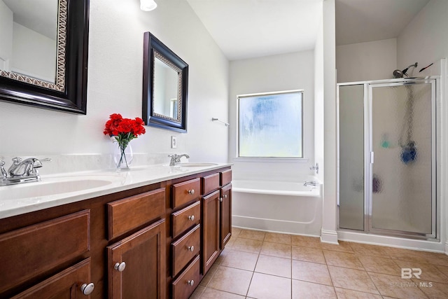 bathroom featuring a stall shower, tile patterned floors, a bath, and double vanity