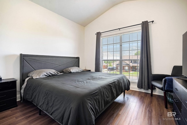 bedroom with lofted ceiling and dark wood-style flooring