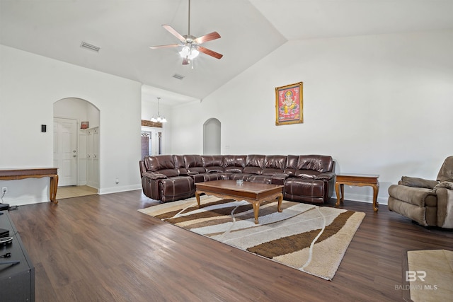 living room featuring arched walkways, ceiling fan, dark wood-style flooring, high vaulted ceiling, and baseboards
