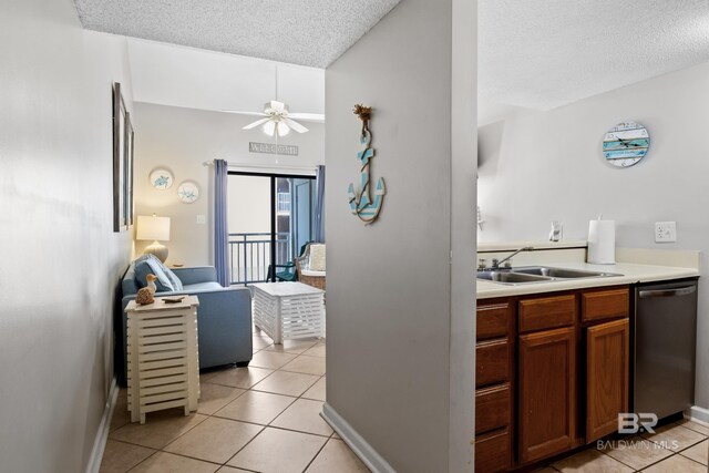 kitchen featuring a kitchen breakfast bar, kitchen peninsula, stainless steel range with electric cooktop, and light tile patterned floors