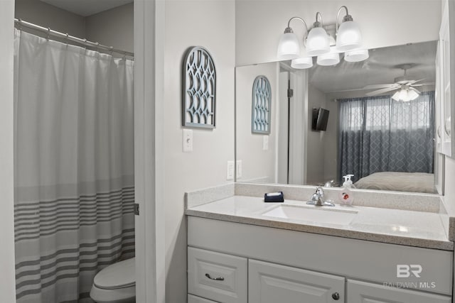 bathroom featuring vanity, ceiling fan, and toilet