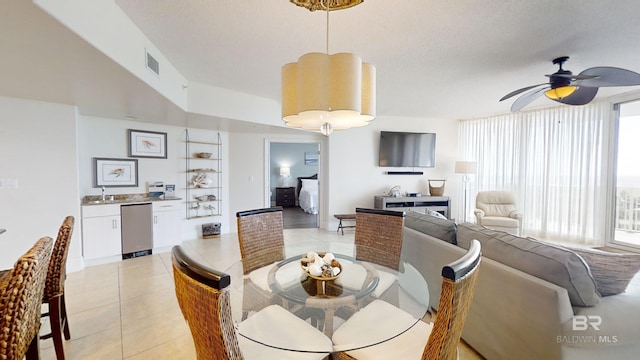 dining space with ceiling fan, visible vents, and light tile patterned floors