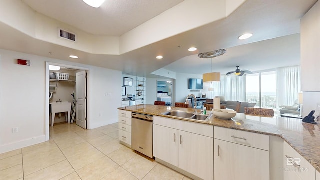 kitchen with visible vents, a sink, open floor plan, hanging light fixtures, and stainless steel dishwasher