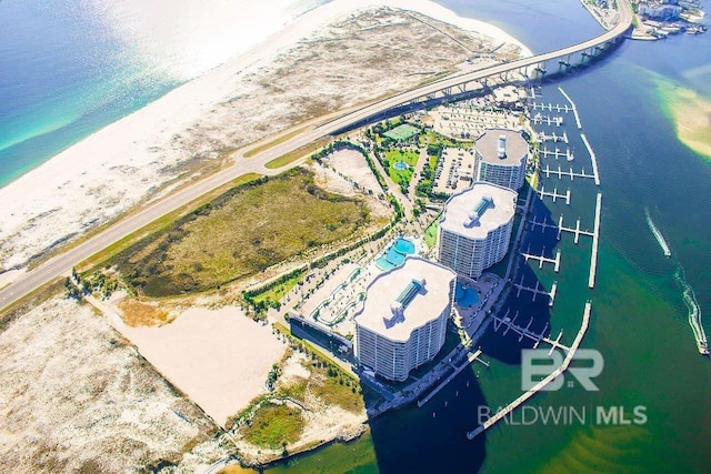 drone / aerial view with a water view and a beach view