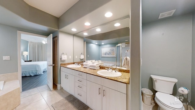 ensuite bathroom featuring a stall shower, visible vents, toilet, and a sink
