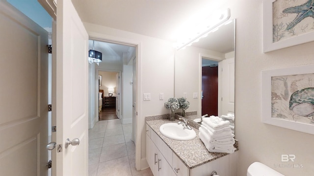 half bathroom with tile patterned floors, toilet, and vanity