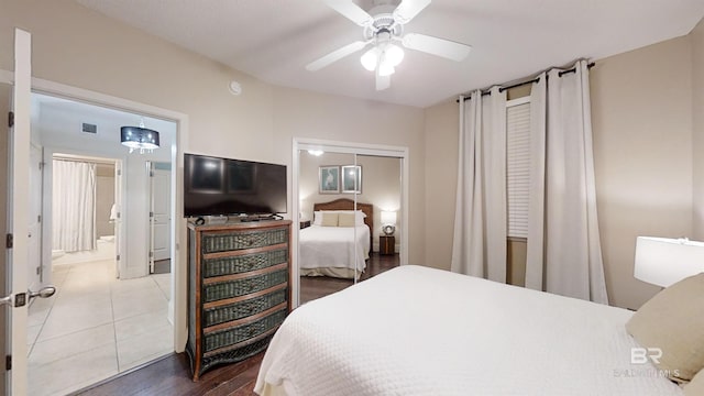 tiled bedroom with visible vents, a closet, and ceiling fan