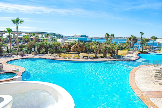 view of swimming pool with a pool with connected hot tub and a patio