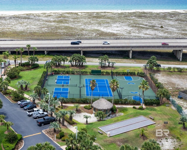 birds eye view of property with a water view and a view of the beach