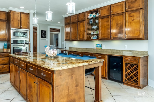 kitchen featuring a kitchen island, hanging light fixtures, appliances with stainless steel finishes, light tile flooring, and wine cooler