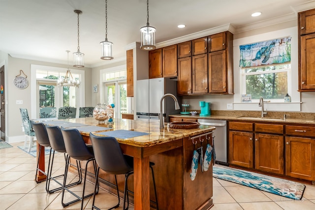 kitchen featuring sink, pendant lighting, light tile floors, dishwasher, and a center island